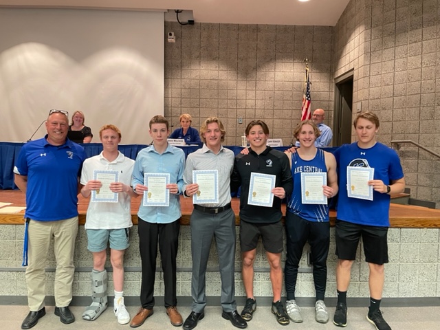 Coach Kilinski with the boys' swimmers who won at the state level.