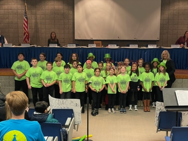 Mrs. Puzey and the Homan Choir entertained the crowd at our School Board meeting.