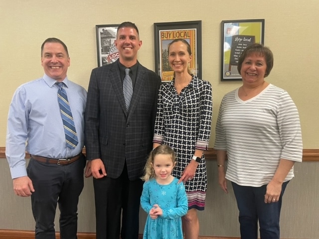 Mr. Newton and Mrs. Kepchar welcome the 2023-24 Kahler Assistant Principal Ryan Vondrak and his family at a recent Board meeting.
