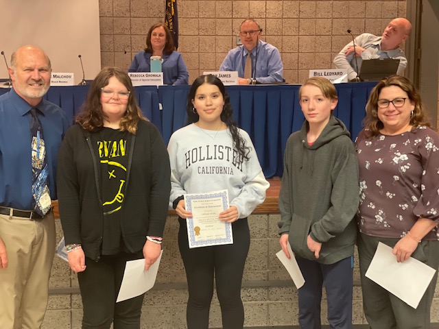 Mr. Graber and Ms Craig congratulate Camden Elmore, Liliana Uribe, and Austin Carlson, winners of the Town of St. John Essay Contest on Student Government Day 2023.