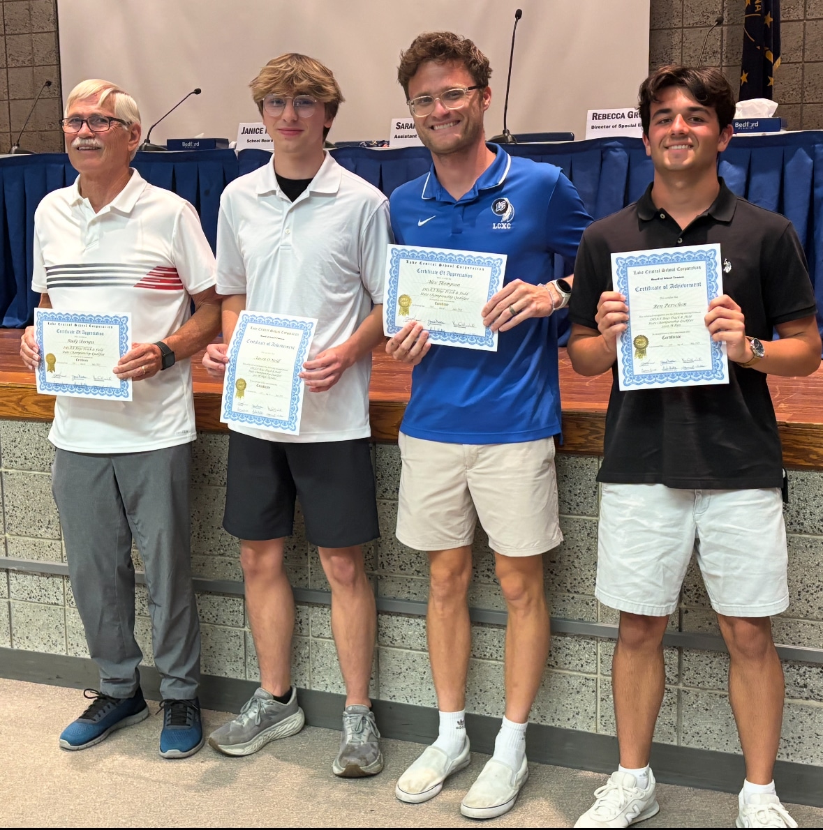 Receiving recognition are Ben Pershon and Aaron O'Neill of the Boys Track & Field team who advanced to the IHSAA State Championships at North Central HS on June 7, 2025. Pictured are Coach Rudy Skorupa, Aaron O'Neill (300 M High Hurdles), Coach Alex Thompson, and Ben Pershon (3200 M Run).