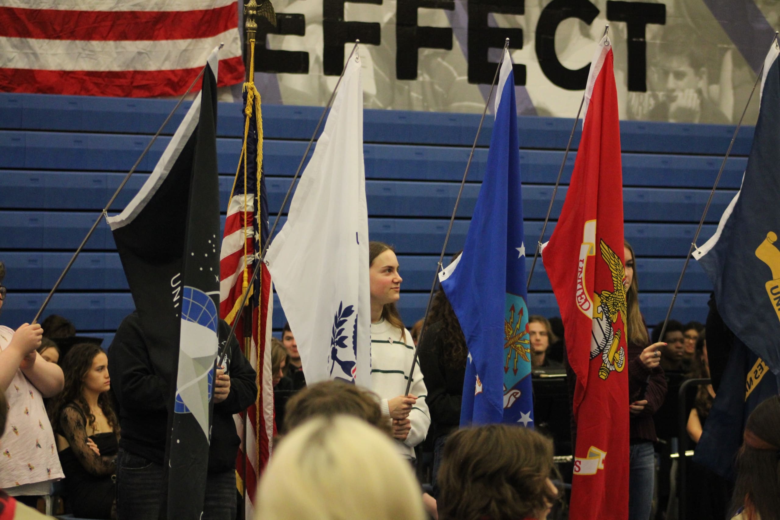 Lake Central students holding the flags of the Armed Forces.